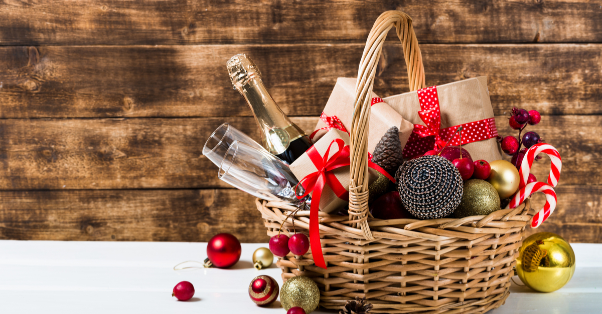 Vibrant Christmas wicker basket with candy cane champagne and presents