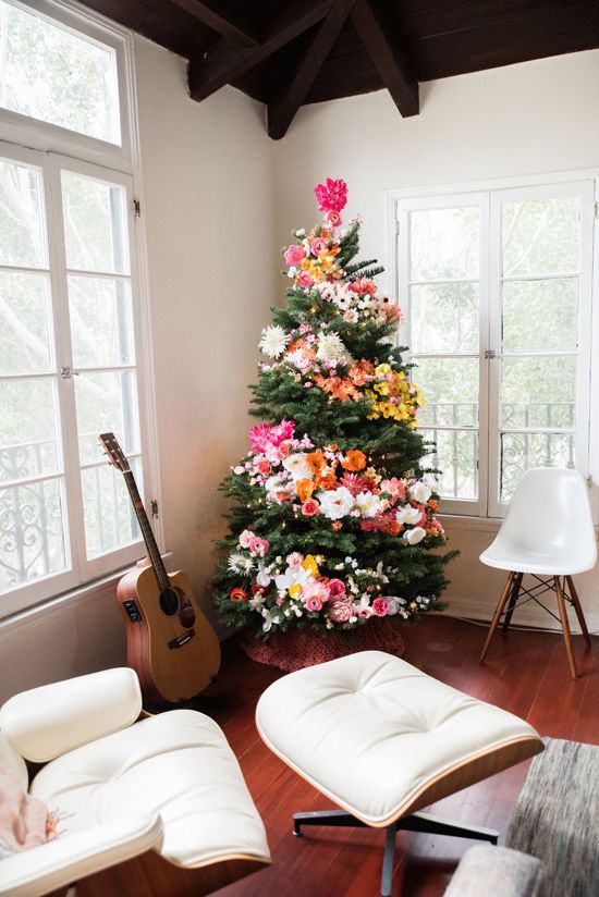 Christmas tree decorated with flowers in rustic home