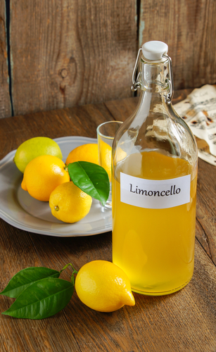 bottle of homemade limoncello with lemons