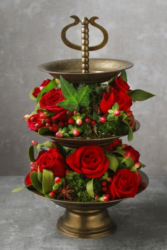 Red Christmas centrepiece with roses.