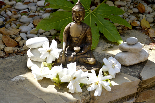 Buddha with white flowers