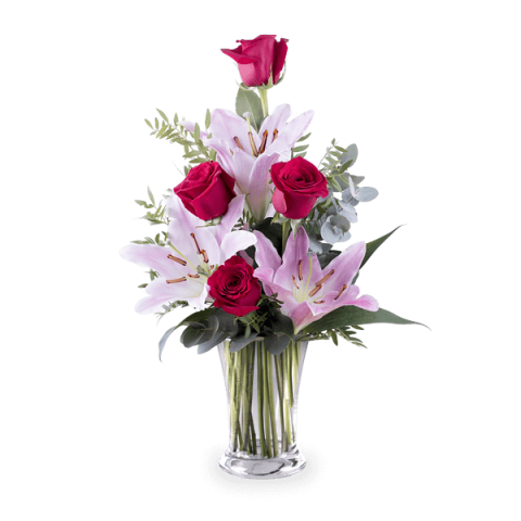 Pink lilies and red roses in a glass vase