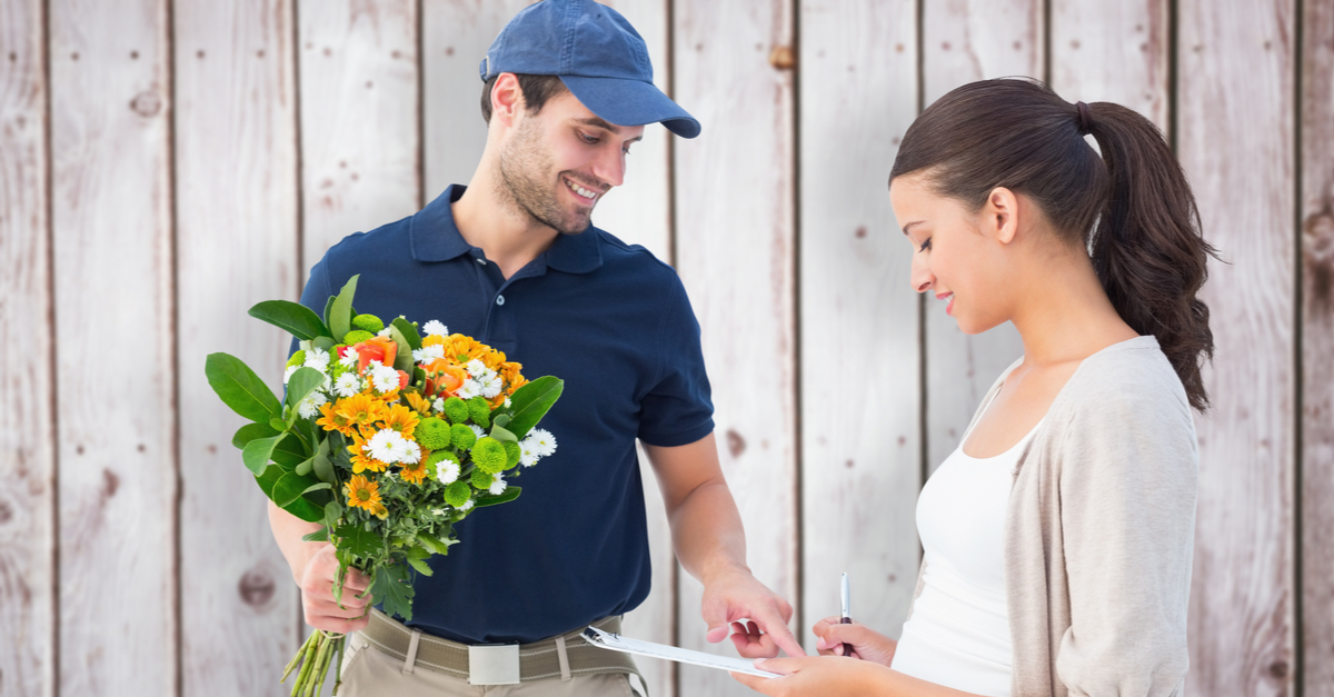 Happy woman receiving flower delivery