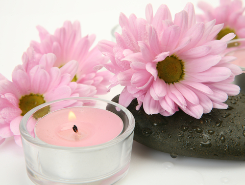 pink Chrysanthemums and pink candles on pebbles