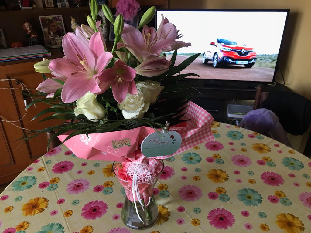 bouquet of pink and white flowers on table in living room