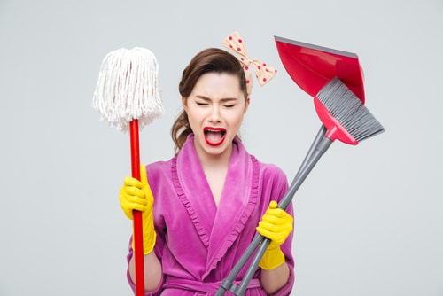 Upset lady with cleaning products