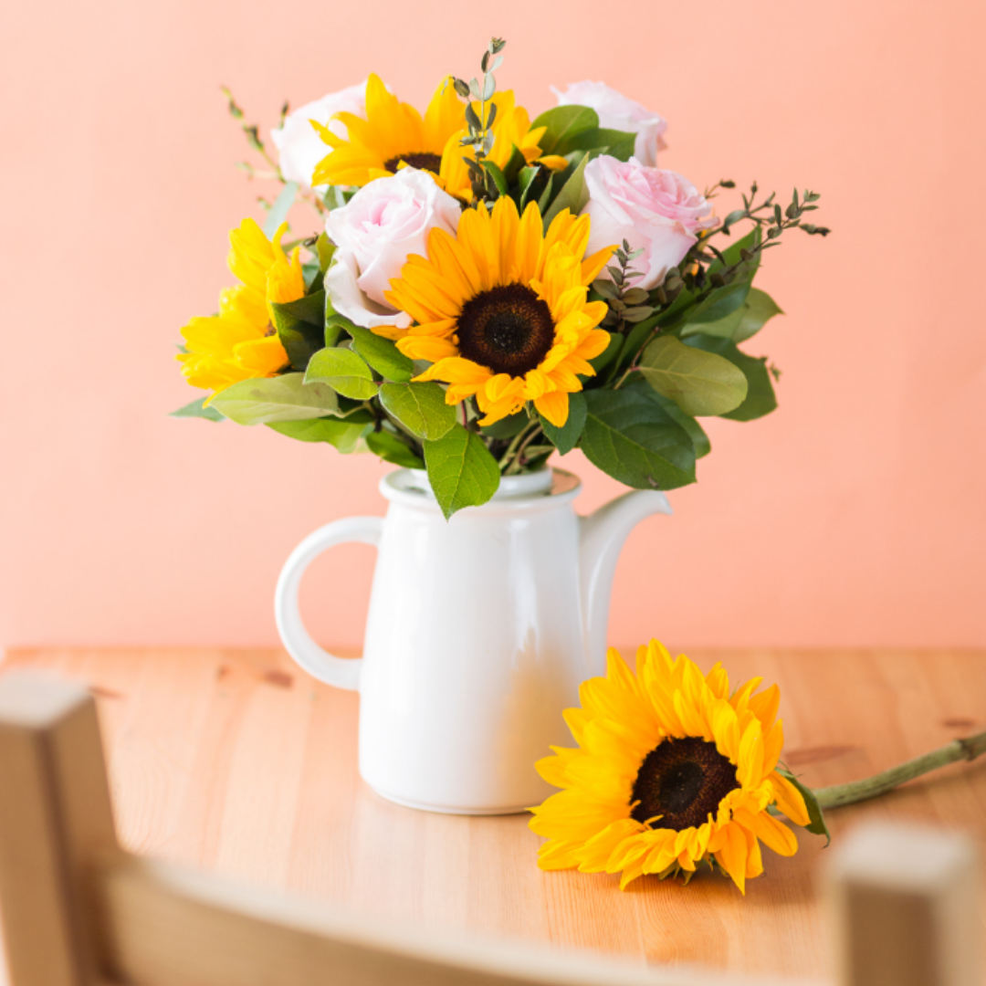 sunflowers and roses in a jug