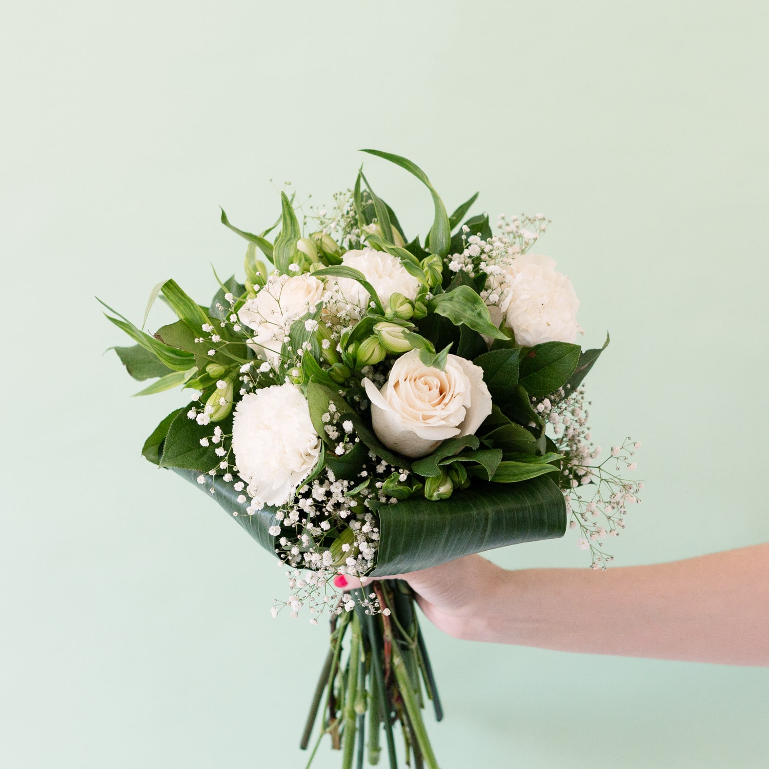 holding white bouquet of roses