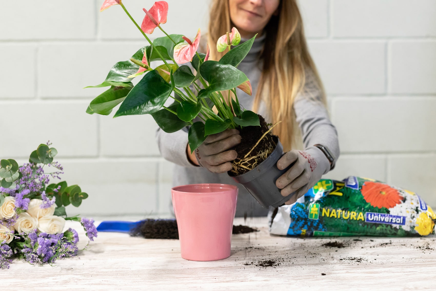 Florist removing plant from old pot