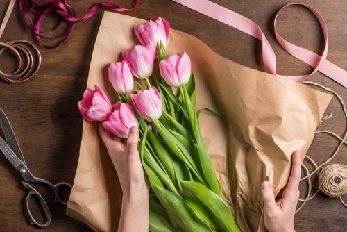 pink tulips being wrapped