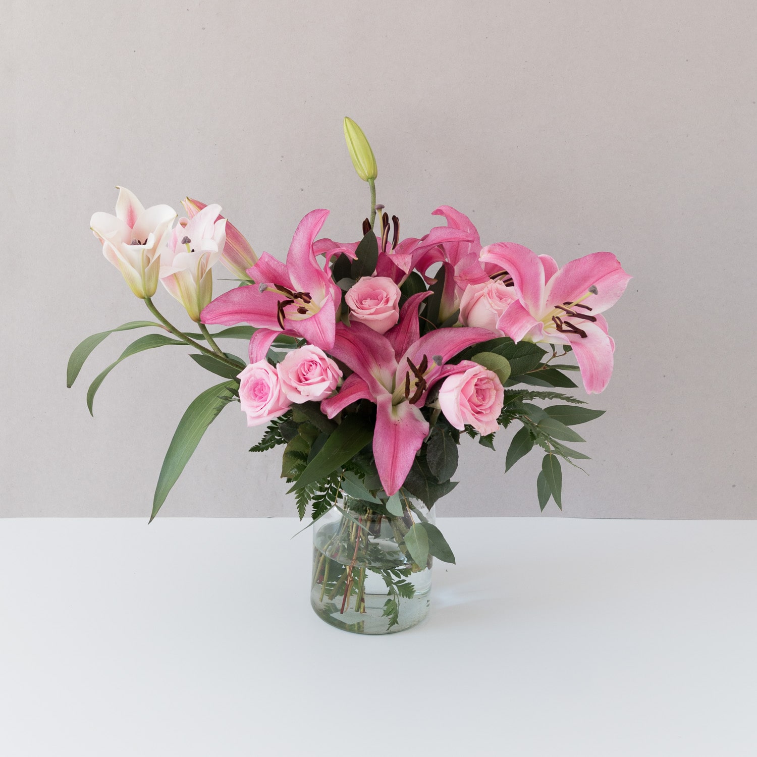 pink roses and lilies in glass vase