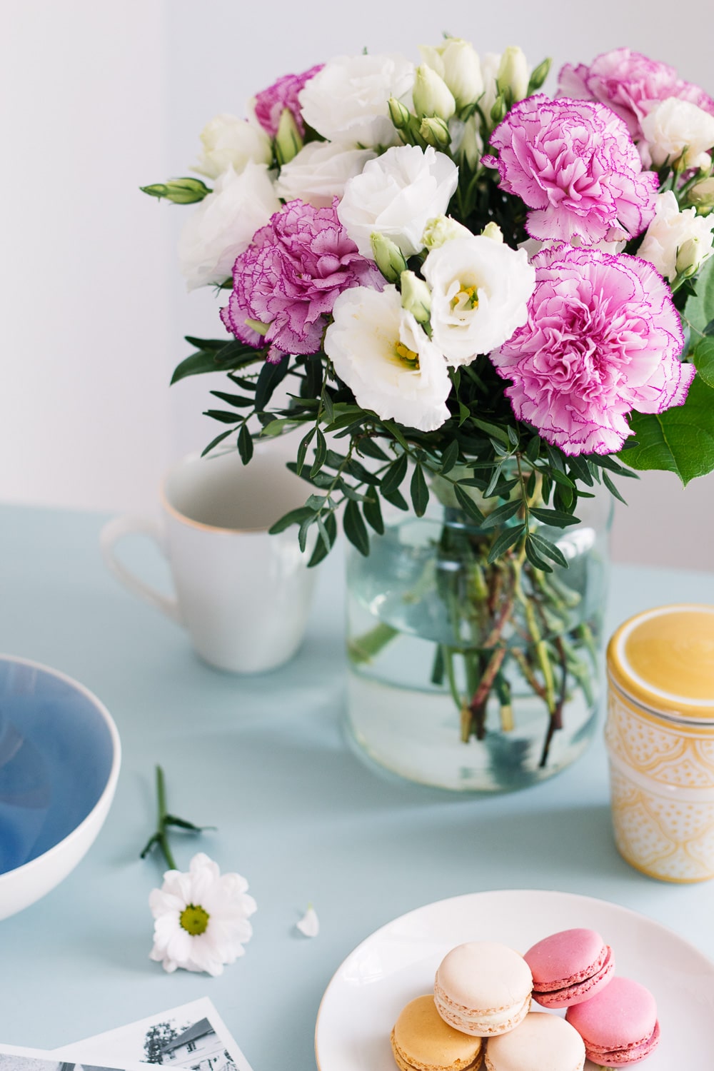 pink carnation and white lisianthus bouquet on breakfast table
