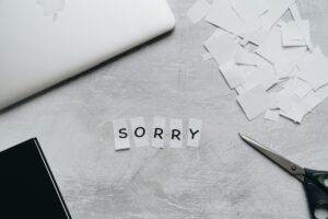 Sorry Text in Pieces of White Paper