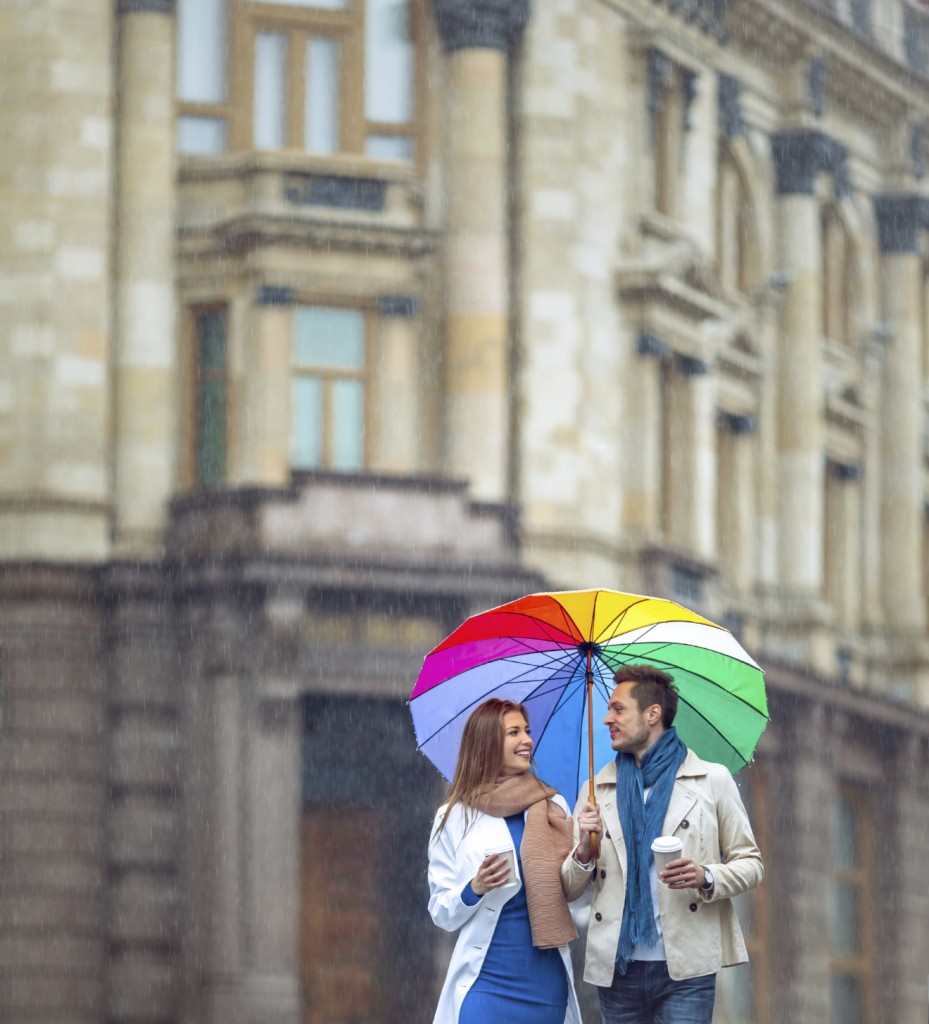 Young couple with an umbrella on the street