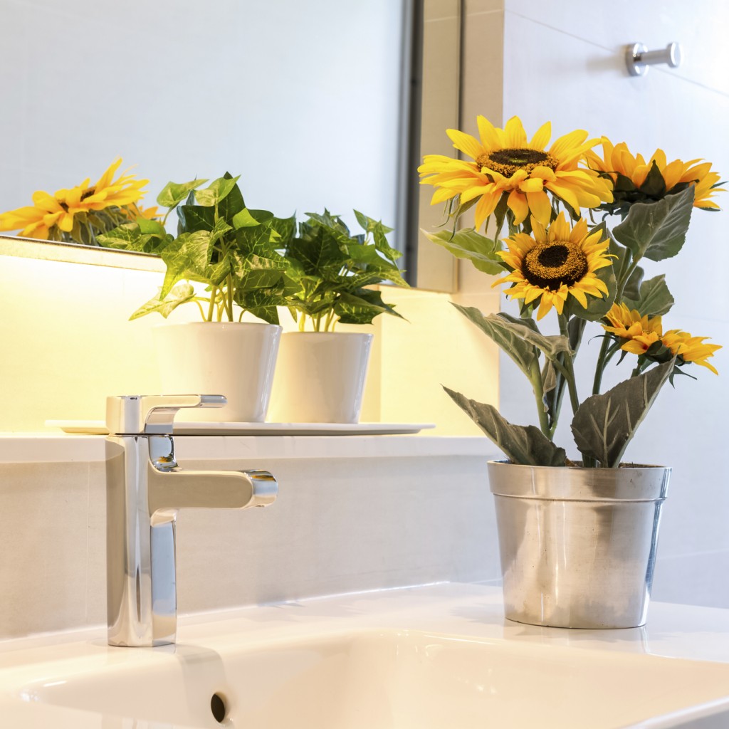 sunflower vase decorated on bathroom sink